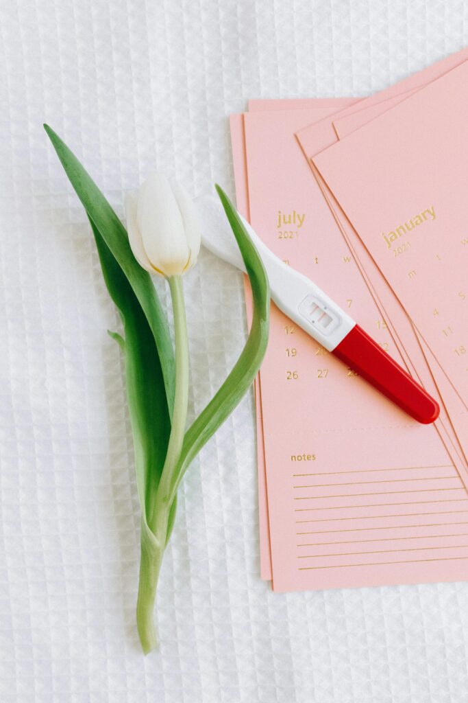 pexels-photo-5982319-5982319 Close-up of a pregnancy test and tulip on a calendar, symbolizing new beginnings.